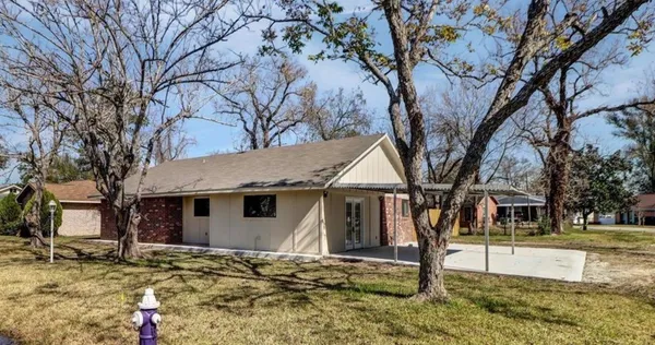 a view of a house with snow on the road