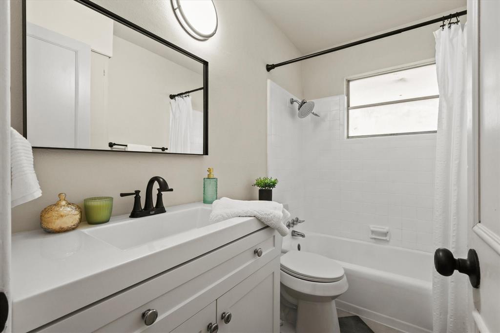 1716 Cordell Street Denton, TX 76201 - Photo 15 of 18 a bathroom with a sink a toilet and a mirror