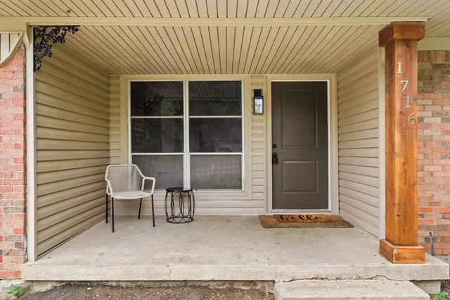 a couple of chairs in front of door