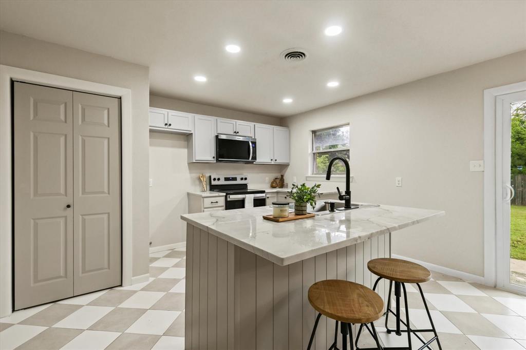 1716 Cordell Street Denton, TX 76201 - Photo 8 of 18 a kitchen with sink cabinets and dining table