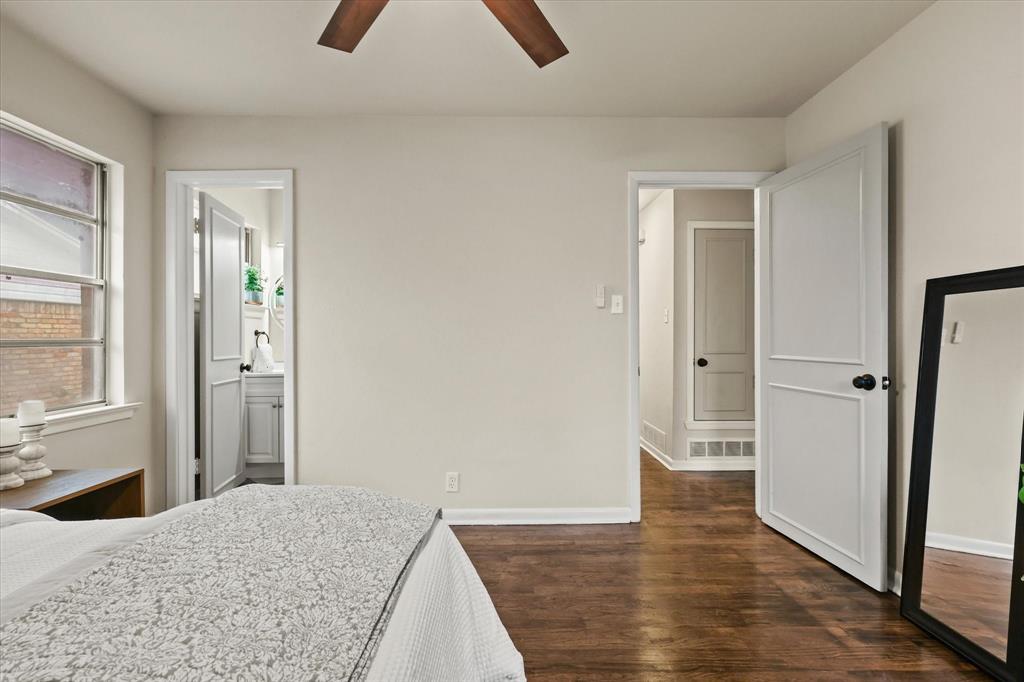 1716 Cordell Street Denton, TX 76201 - Photo 9 of 18 a view of a bedroom with wooden floor and a bathroom
