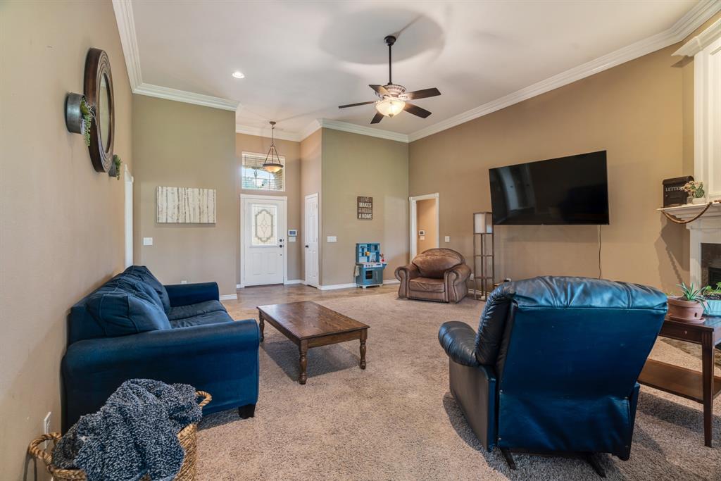 1810 Meadowview Drive Reno, TX 75462 - Photo 6 of 17 a living room with furniture a flat screen tv and kitchen view
