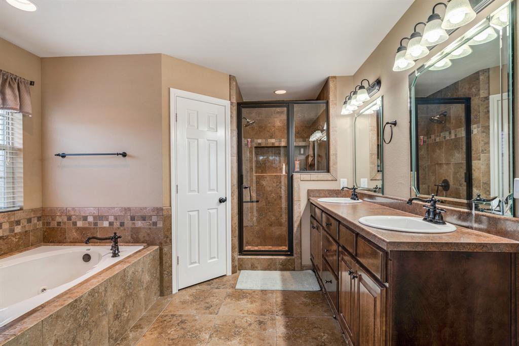 1810 Meadowview Drive Reno, TX 75462 - Photo 8 of 17 a spacious bathroom with a tub sink shower and mirror