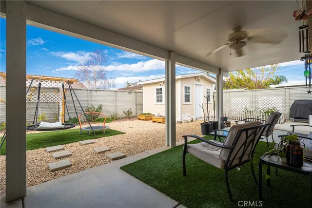 a swimming pool with outdoor seating and yard