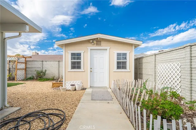 a view of a house with a backyard