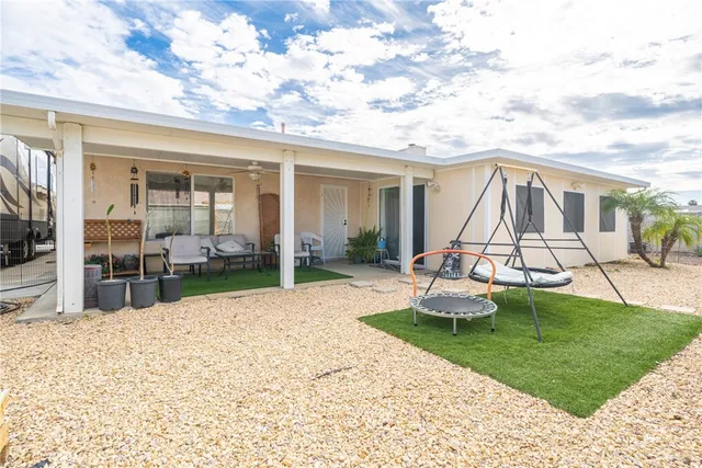a view of a house with backyard porch and sitting area