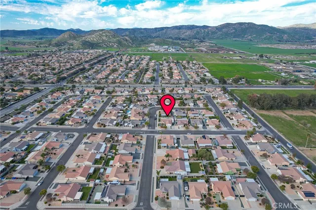 an aerial view of residential houses with outdoor space and river