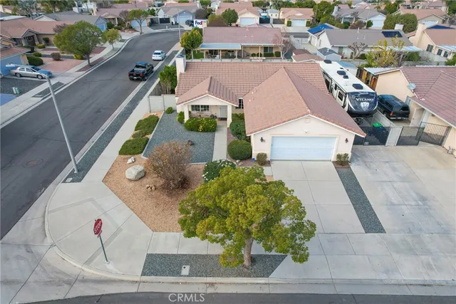 an aerial view of a house with a yard