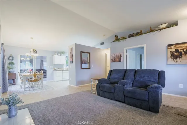 a living room with furniture and a dining room