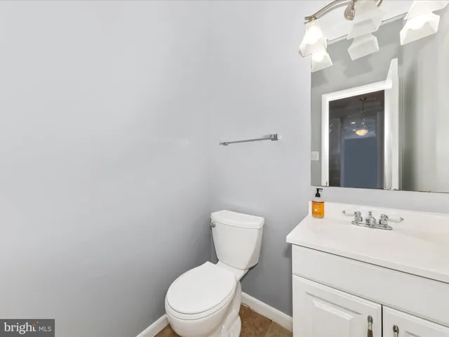 a white toilet sitting next to a bathroom sink