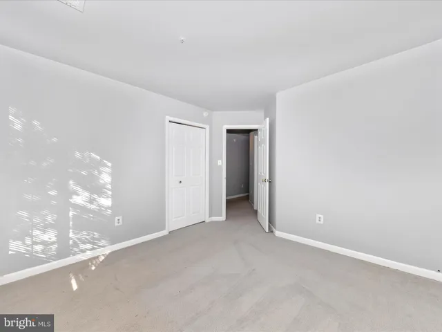 a view of an empty room with a chandelier