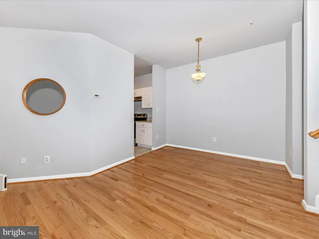 a view of a room with wooden floor and window