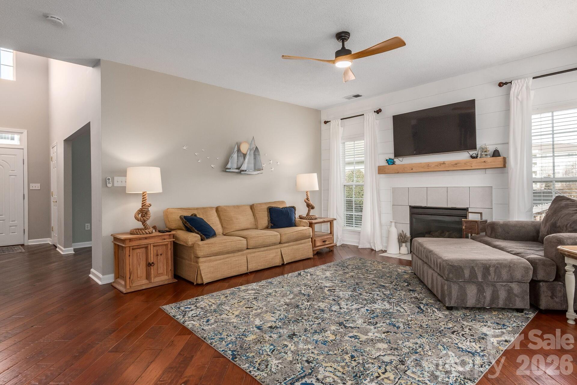 156 Lighthouse Road Mount Holly, NC 28120 - Photo 11 of 39 a living room with furniture a flat screen tv and a fireplace