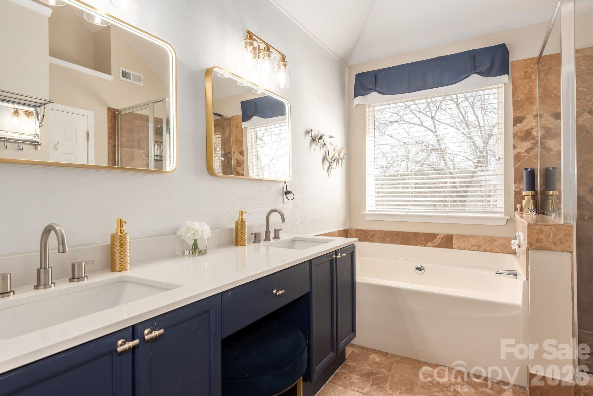 156 Lighthouse Road Mount Holly, NC 28120 - Photo 15 of 39 a bathroom with a tub double sink window and mirror