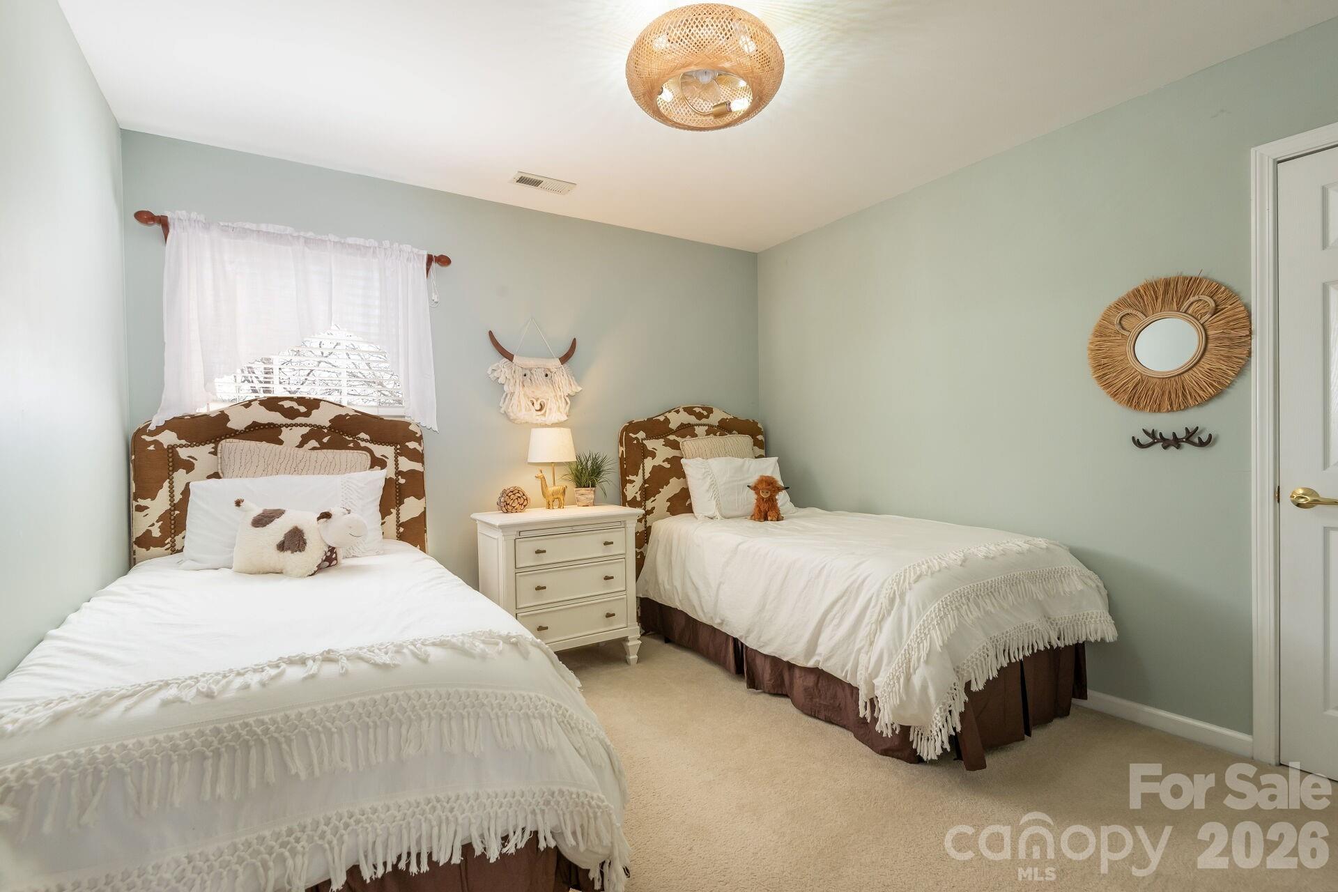 156 Lighthouse Road Mount Holly, NC 28120 - Photo 18 of 39 a bedroom with two beds and a chair
