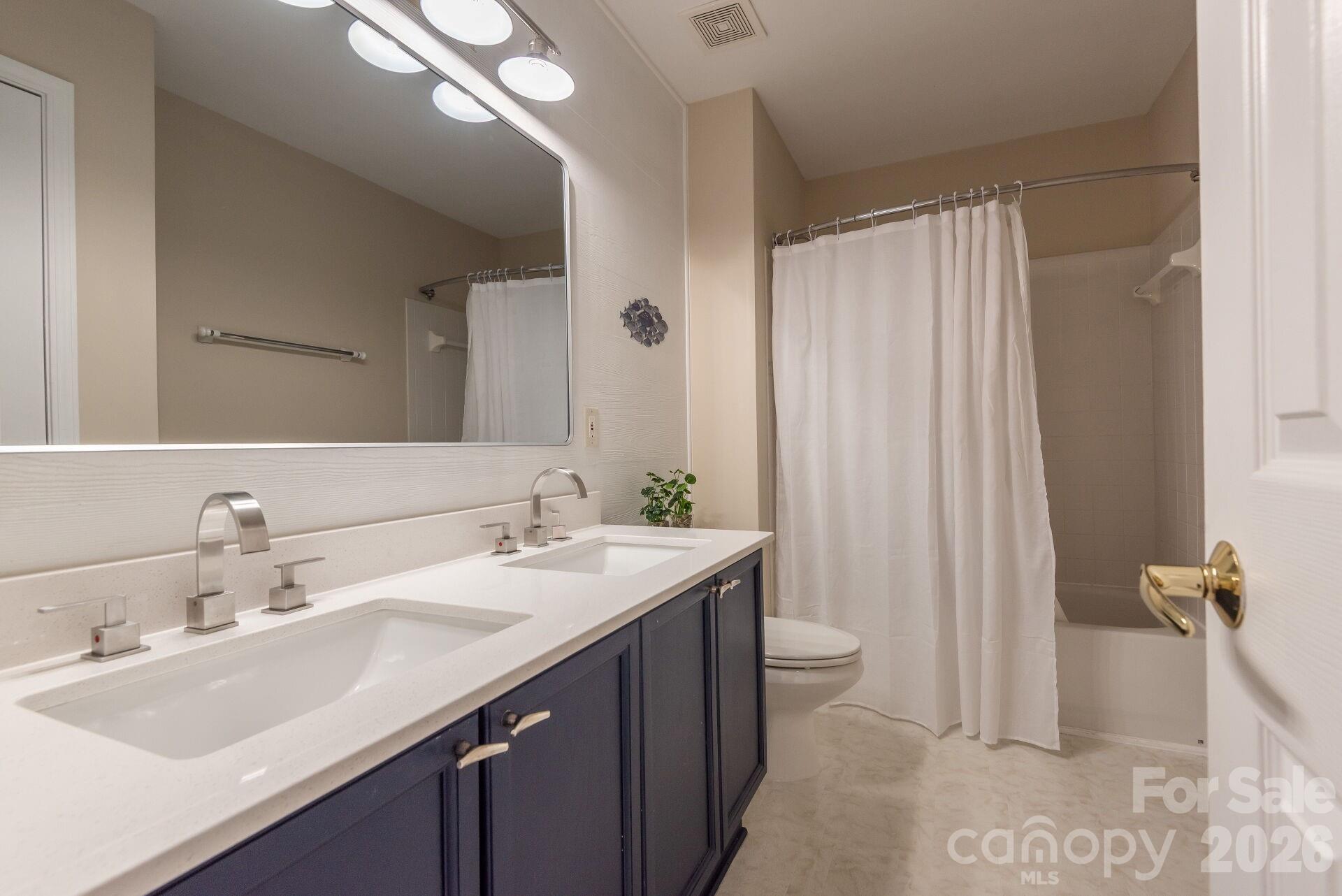 156 Lighthouse Road Mount Holly, NC 28120 - Photo 22 of 39 a bathroom with a double vanity sink toilet and a mirror