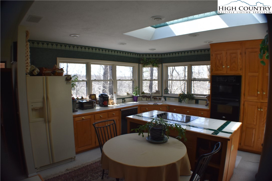 258 Ivy Road Newland, NC 28657 - Photo 18 of 26 a view of a dining room with furniture window and wooden floor