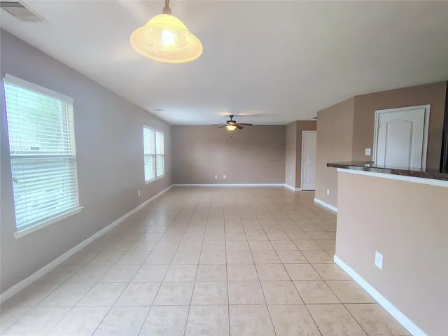 a view of empty room with window and fireplace