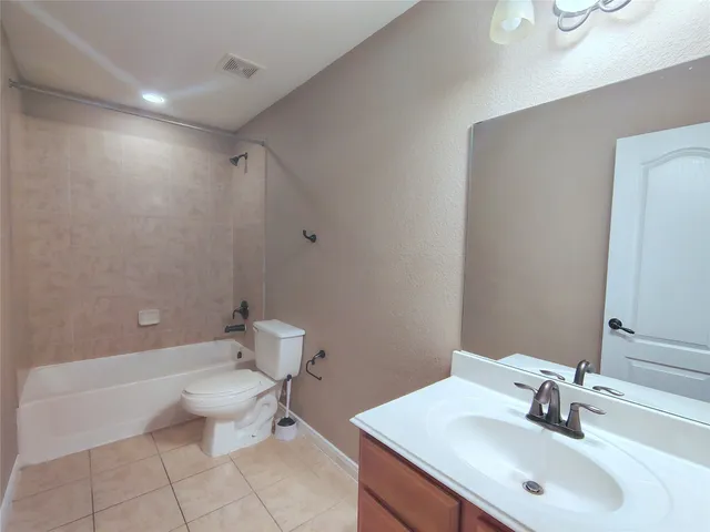 a bathroom with a sink toilet and a mirror