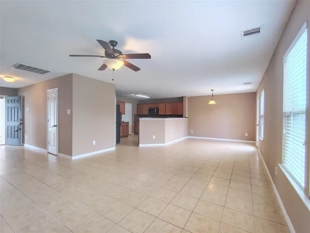 a view of a livingroom with a ceiling fan and window