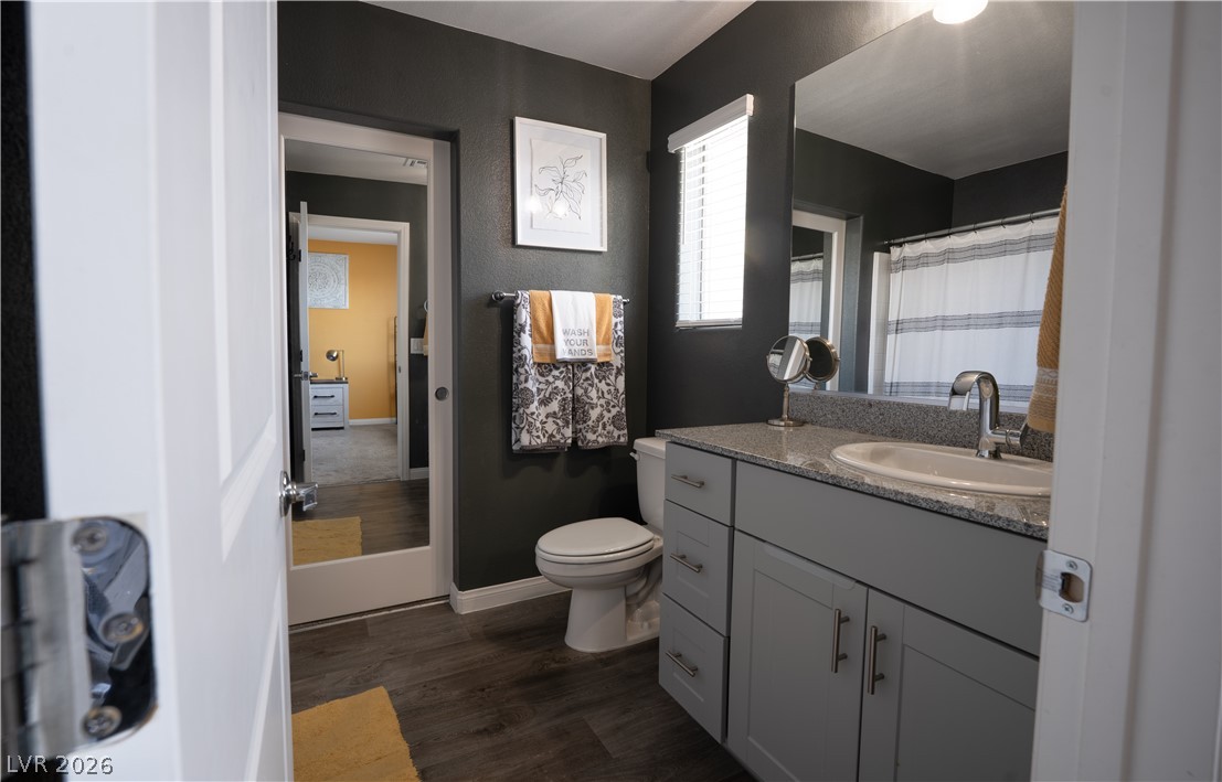 12267 Desert Light Road, Unit 4 Las Vegas, NV 89183 - Photo 8 of 18 Primary bathroom features a contemporary vanity with a granite countertop and a full mirror.