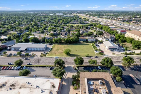 an aerial view of a residential houses with outdoor space