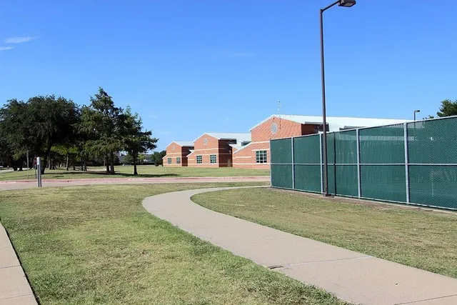a view of yard with swimming pool and trees