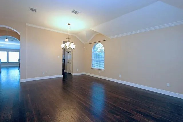 a view of a room with wooden floor chandelier and entryway