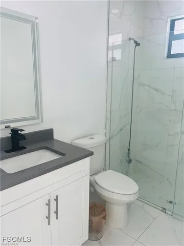 a bathroom with a sink window and a shower