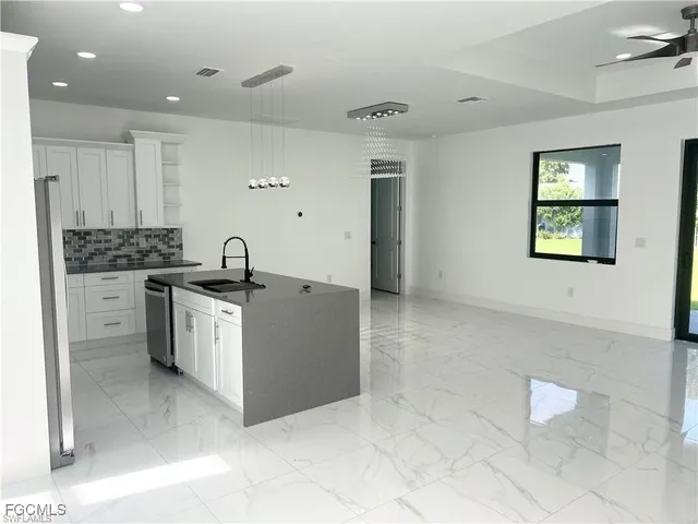 a kitchen with a sink cabinets and window