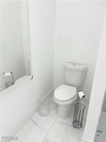 a white toilet sitting next to a white sink