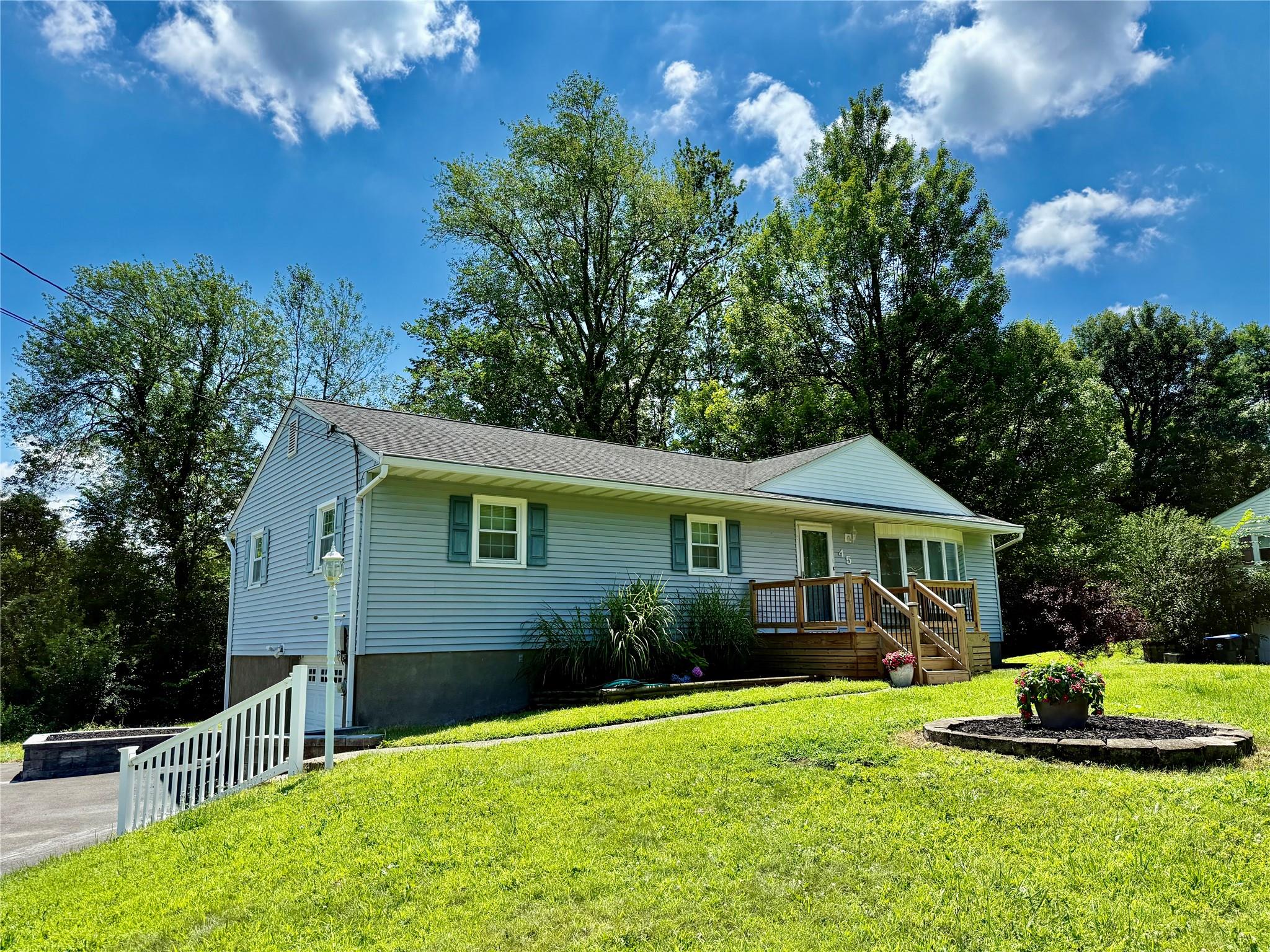 a view of a house with a yard and a garden