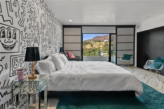 a bathroom with a sink a large mirror and shower