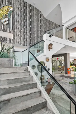 a living room with stainless steel appliances furniture and a large window