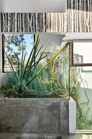 a view of a balcony with chairs and a potted plant