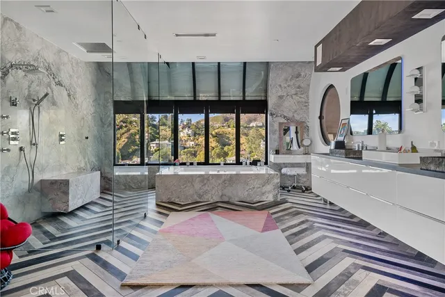a view of a living room with lots of chairs and mirrors