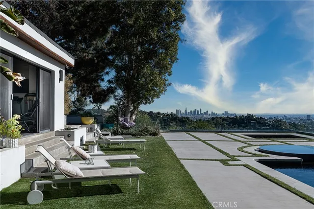 a view of swimming pool with seating space and hardwood floor