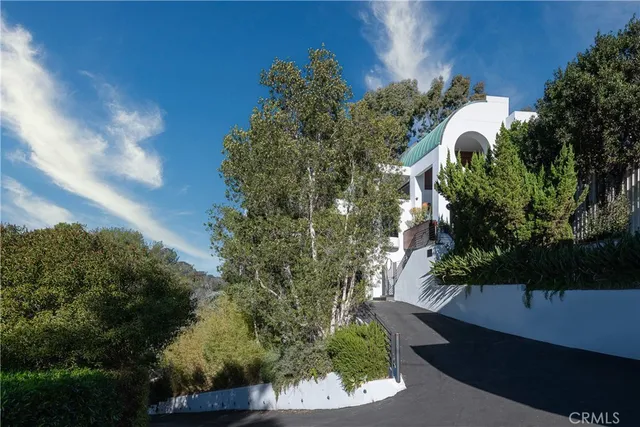 a living room with furniture and potted plant