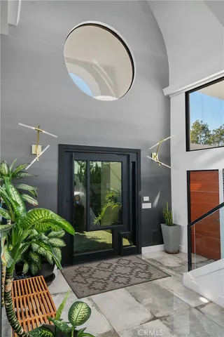 a living room filled with furniture and a potted plant