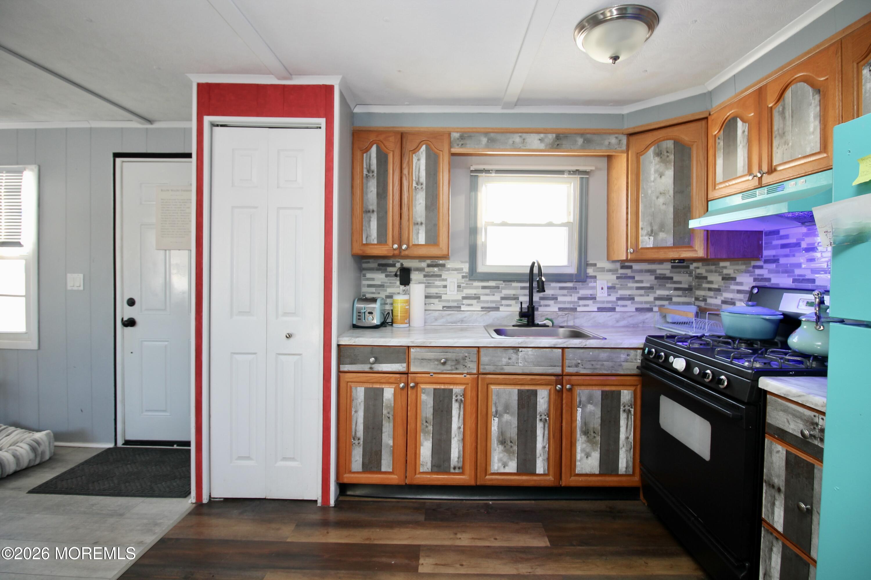509 Rosalind Road Freehold, NJ 07728 - Photo 11 of 24 a kitchen with stainless steel appliances granite countertop a stove and a sink