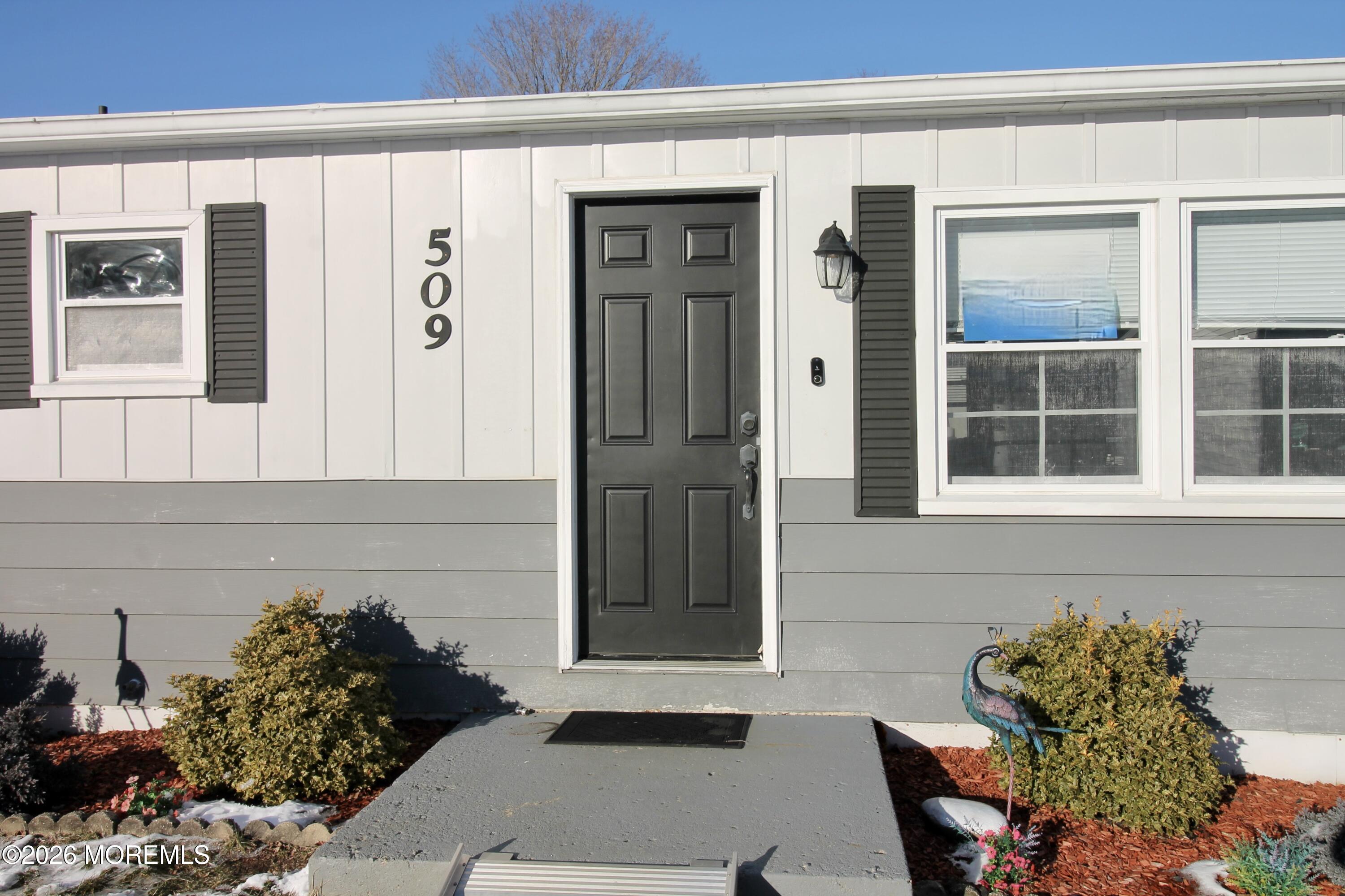 509 Rosalind Road Freehold, NJ 07728 - Photo 13 of 25 a couple of potted plants in front of a house