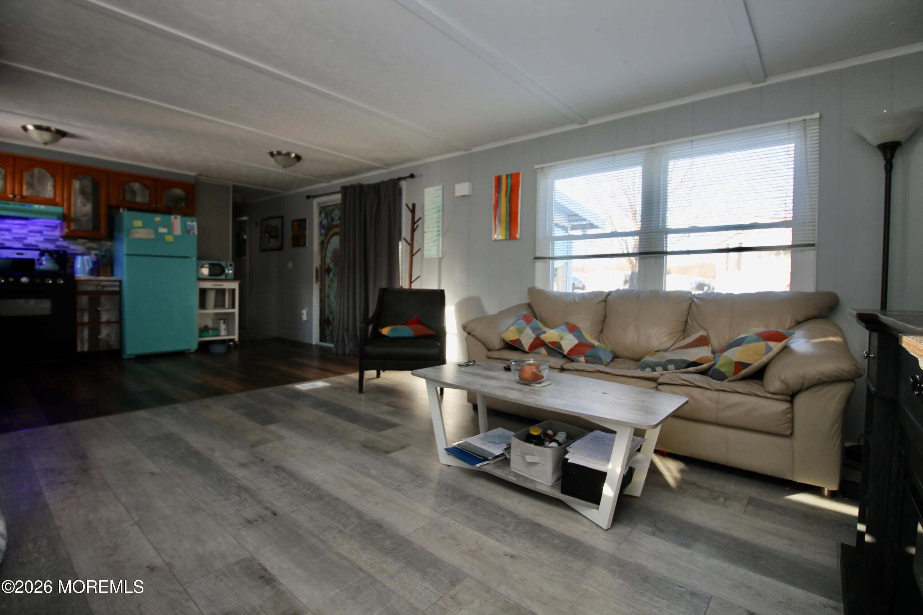 509 Rosalind Road Freehold, NJ 07728 - Photo 15 of 25 a living room with furniture gym equipment and a large window