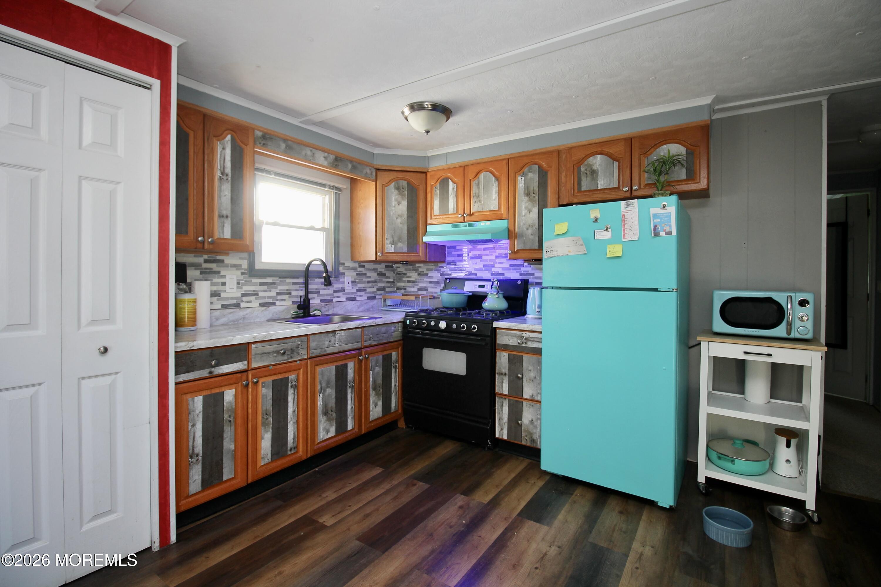 509 Rosalind Road Freehold, NJ 07728 - Photo 17 of 25 a kitchen with stainless steel appliances granite countertop a stove and a refrigerator