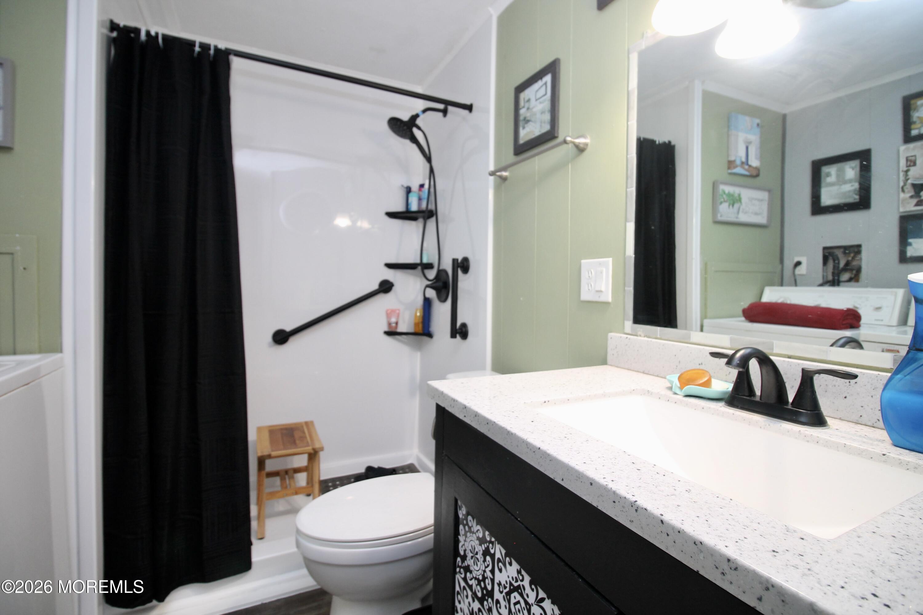 509 Rosalind Road Freehold, NJ 07728 - Photo 23 of 25 a bathroom with a sink toilet vanity and shower