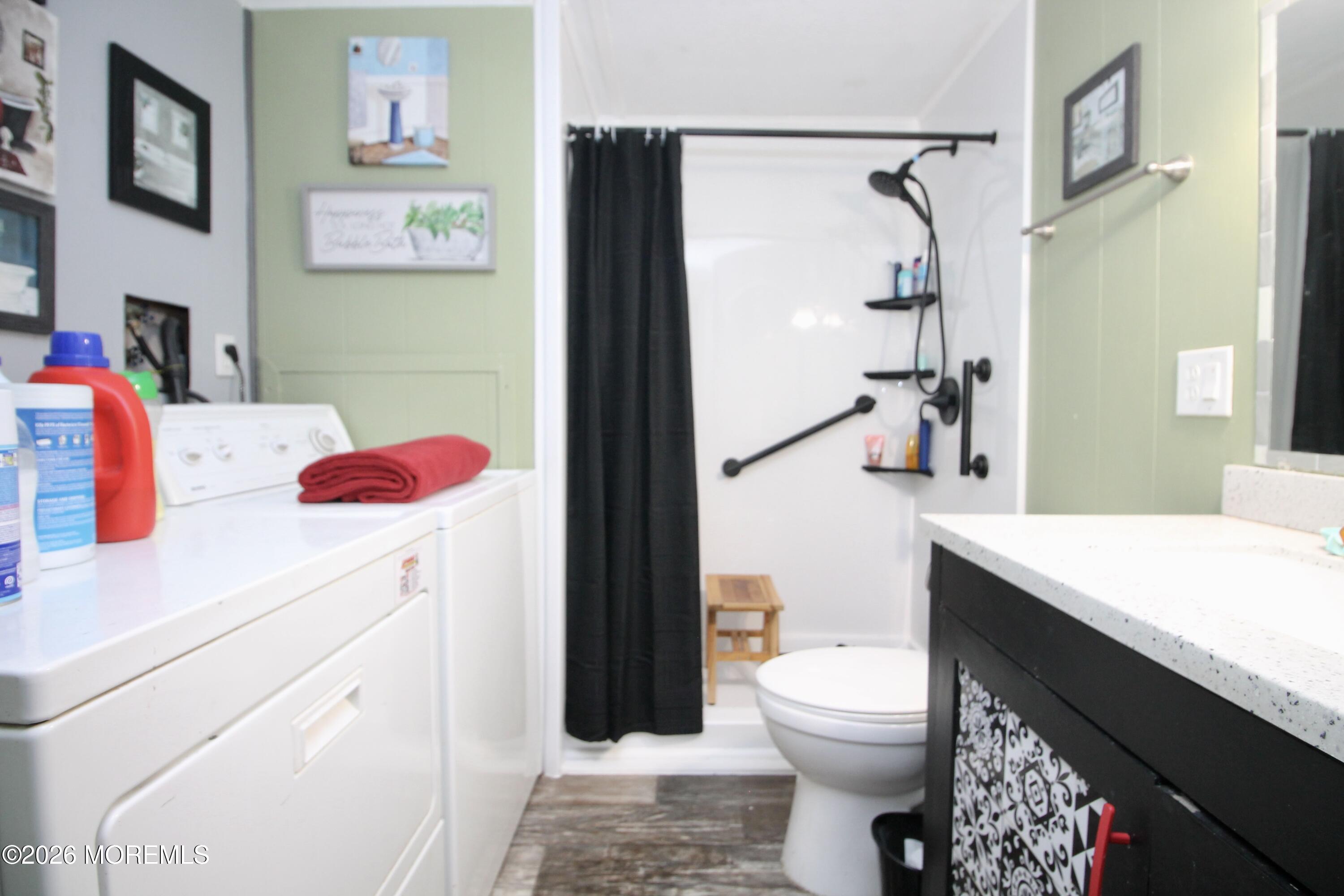 509 Rosalind Road Freehold, NJ 07728 - Photo 24 of 25 a bathroom with a sink vanity mirror and toilet