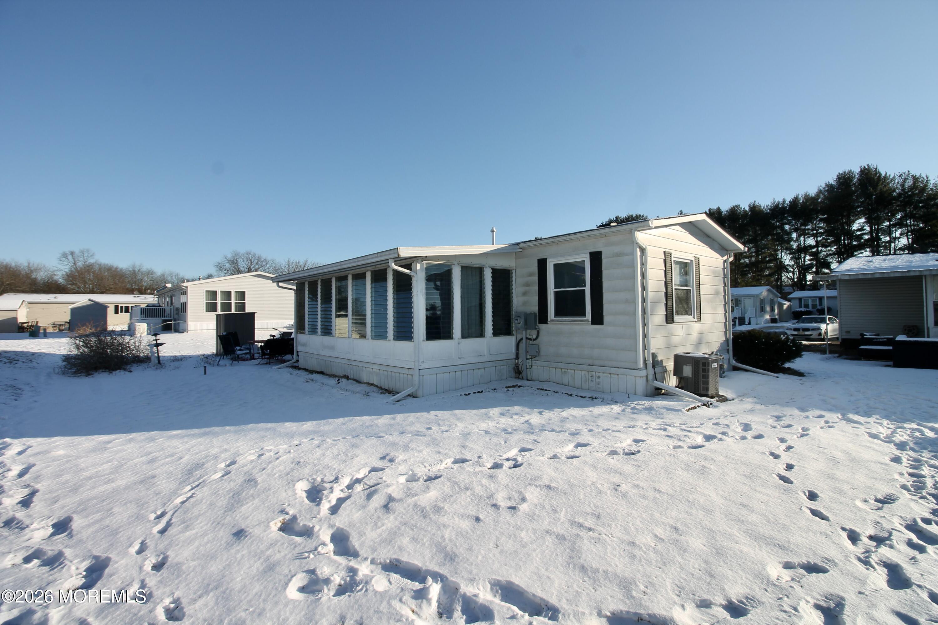 509 Rosalind Road Freehold, NJ 07728 - Photo 4 of 25 a front view of a house with a yard covered in snow