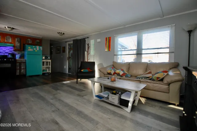 a living room with furniture gym equipment and a large window