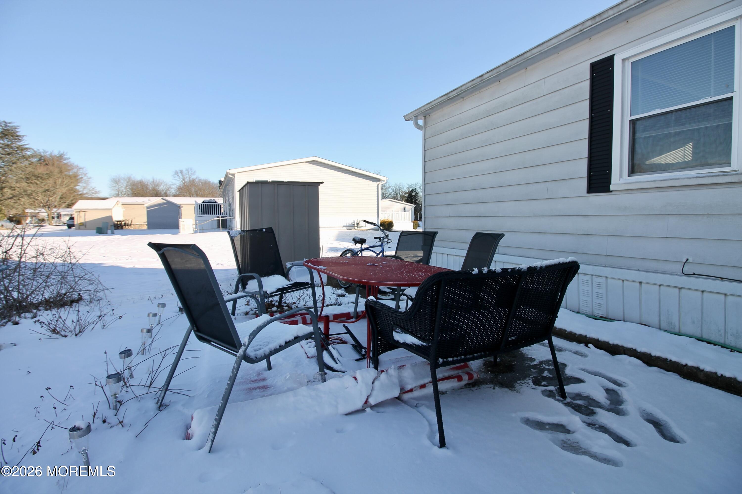509 Rosalind Road Freehold, NJ 07728 - Photo 7 of 25 a patio with table and chairs and potted plants