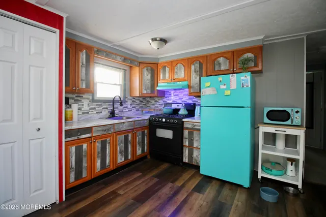 a kitchen with stainless steel appliances granite countertop a stove and a refrigerator
