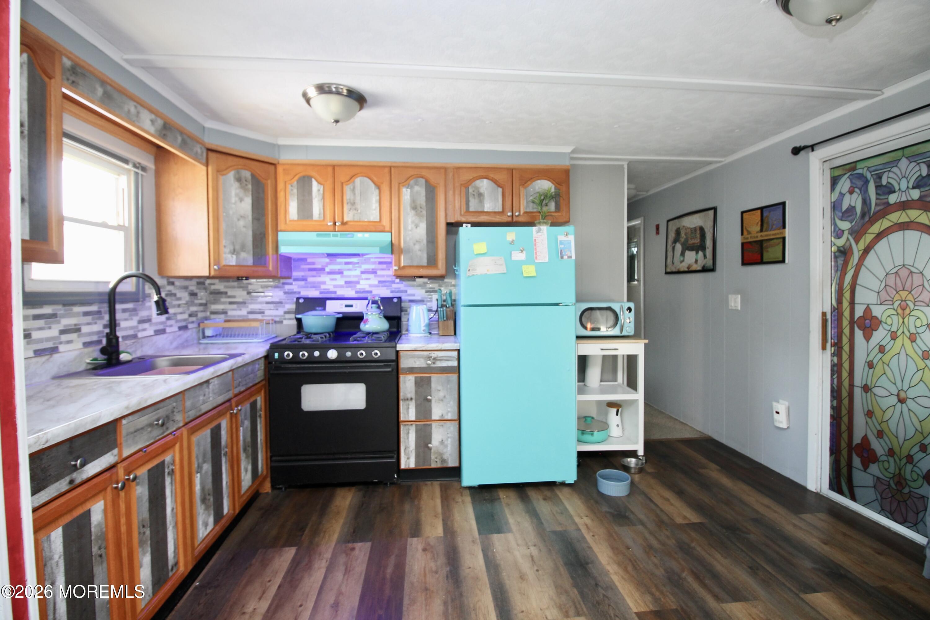 509 Rosalind Road Freehold, NJ 07728 - Photo 10 of 24 a kitchen with stainless steel appliances granite countertop a stove a sink and a refrigerator